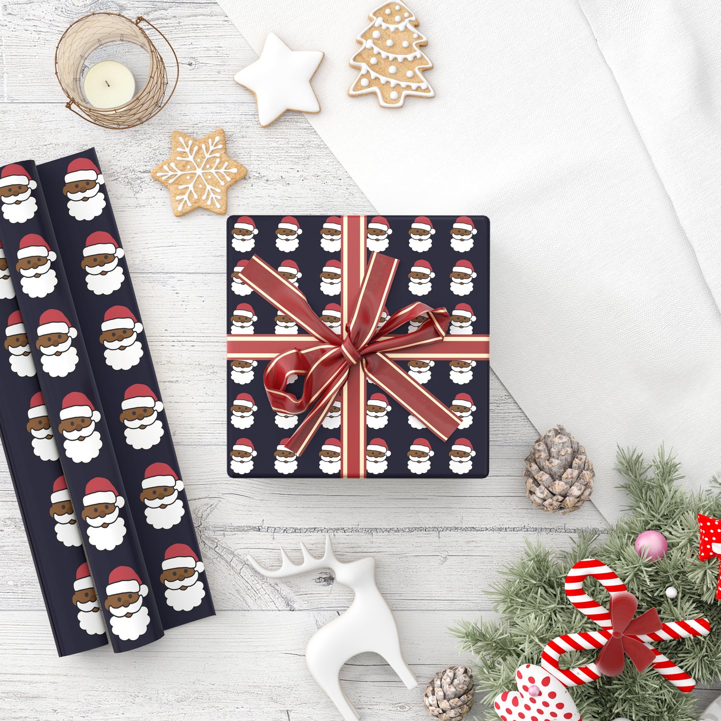 A roll of playful holiday wrapping paper featuring a Santa Claus design decorated with fun emoji patterns.