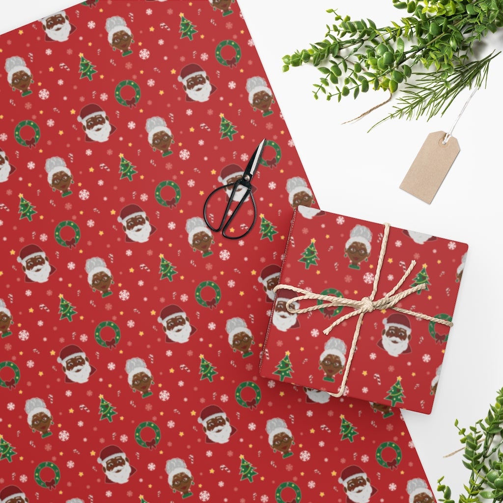 A roll of festive holiday wrapping paper featuring a Black Santa Claus design framed by a traditional wreath.